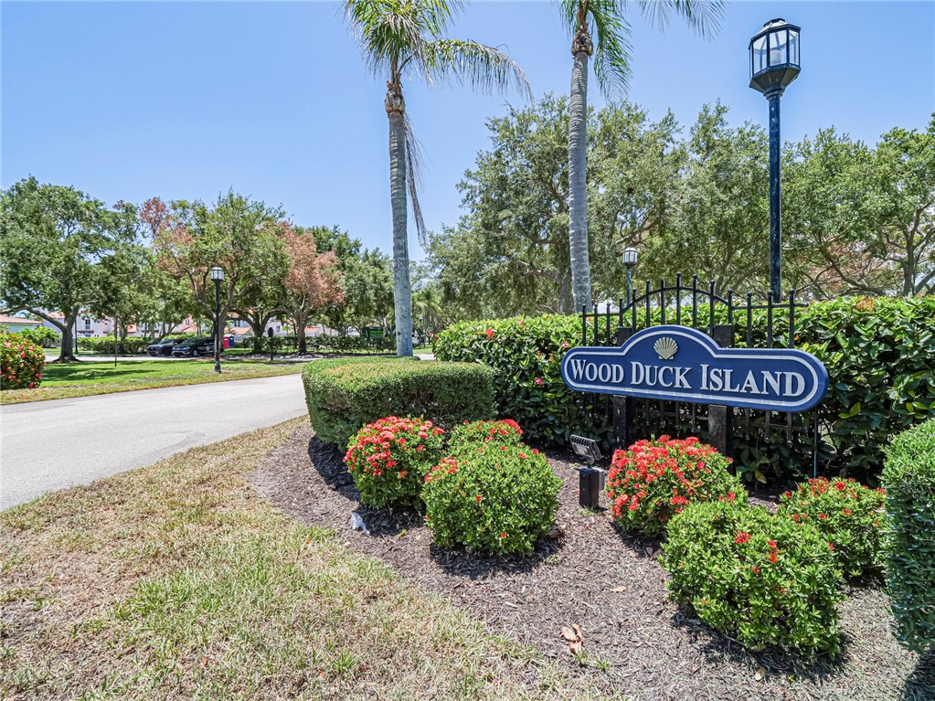 a sign that is sitting in front of flowers