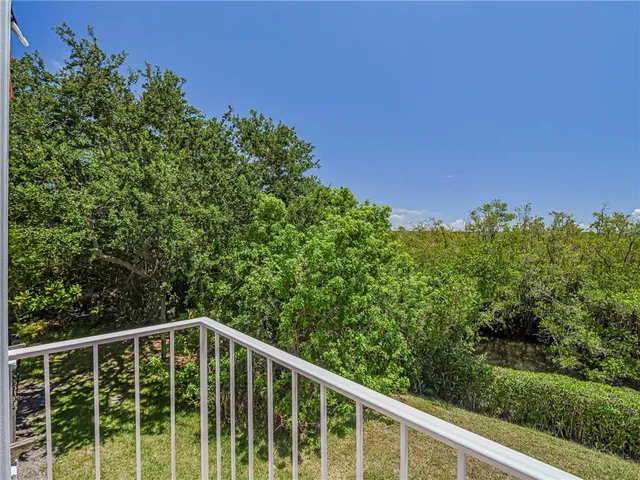 a balcony with trees in front of it