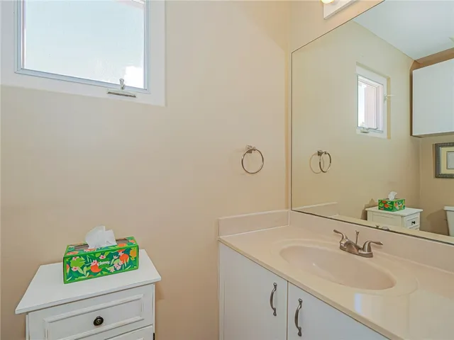 a bathroom with a sink vanity and a mirror