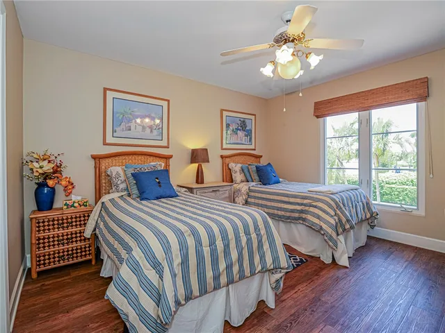 a bedroom with two beds and a chandelier