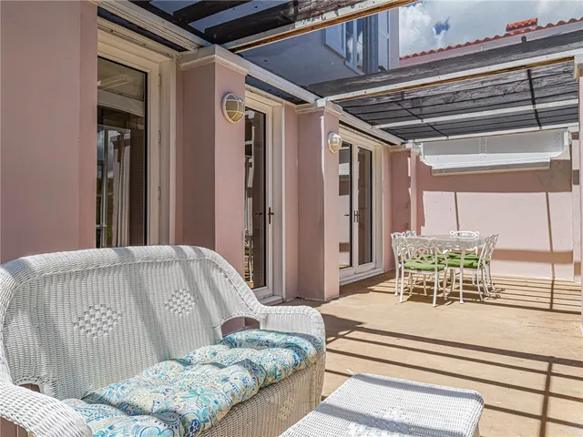 a view of a patio with table and chairs and potted plants