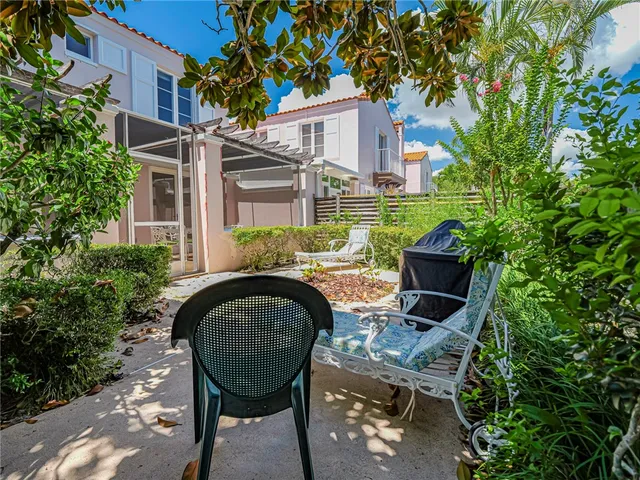 a view of a patio with table and chairs and potted plants