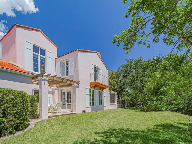 an aerial view of multiple houses with yard