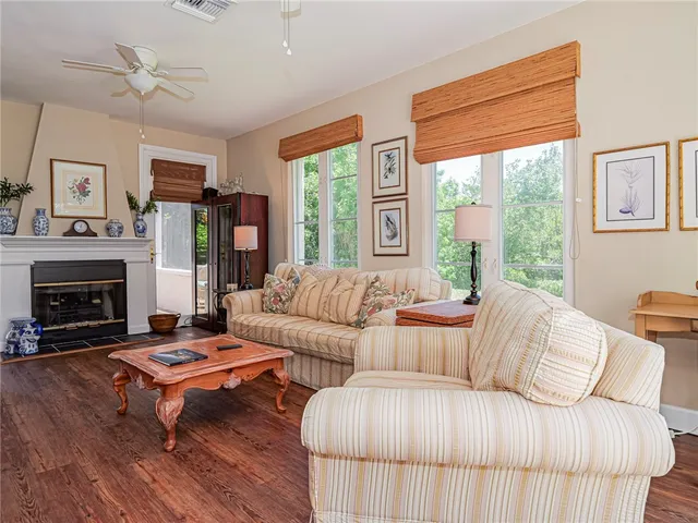 a living room with furniture large window and a fireplace