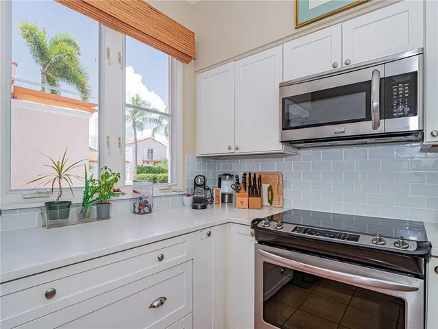 a kitchen with stainless steel appliances a stove a microwave and cabinets