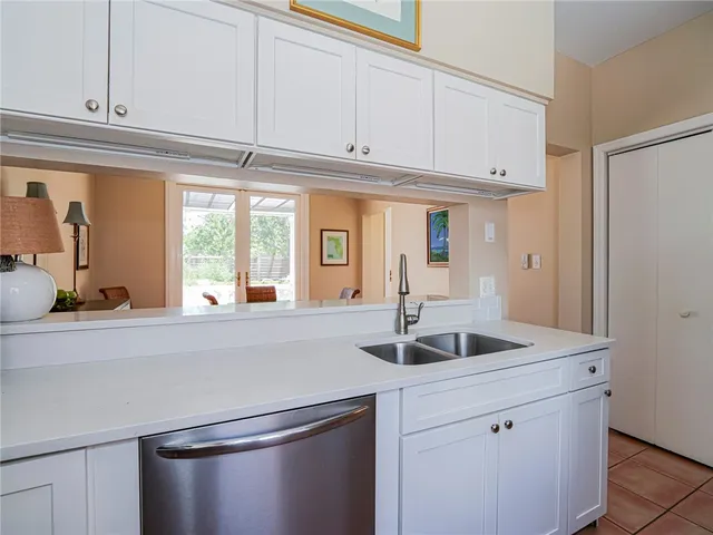 a kitchen with granite countertop a sink and cabinets