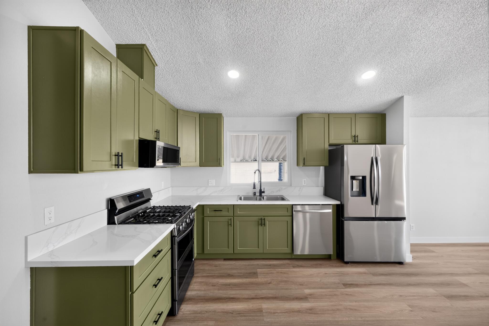 15181 Van Buren Boulevard, Unit 102 Riverside, CA 92504 - Photo 13 of 29 a kitchen with stainless steel appliances granite countertop a sink stove and refrigerator