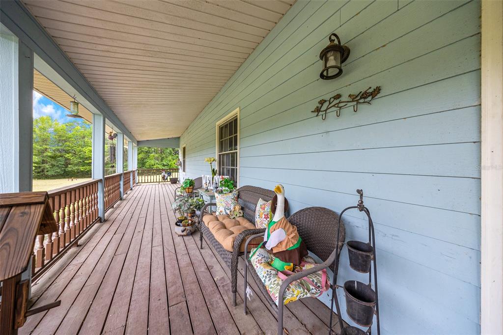 732 Carl Wilson Road Fort White, FL 32038 - Photo 32 of 80 a view of a balcony with furniture and wooden floor