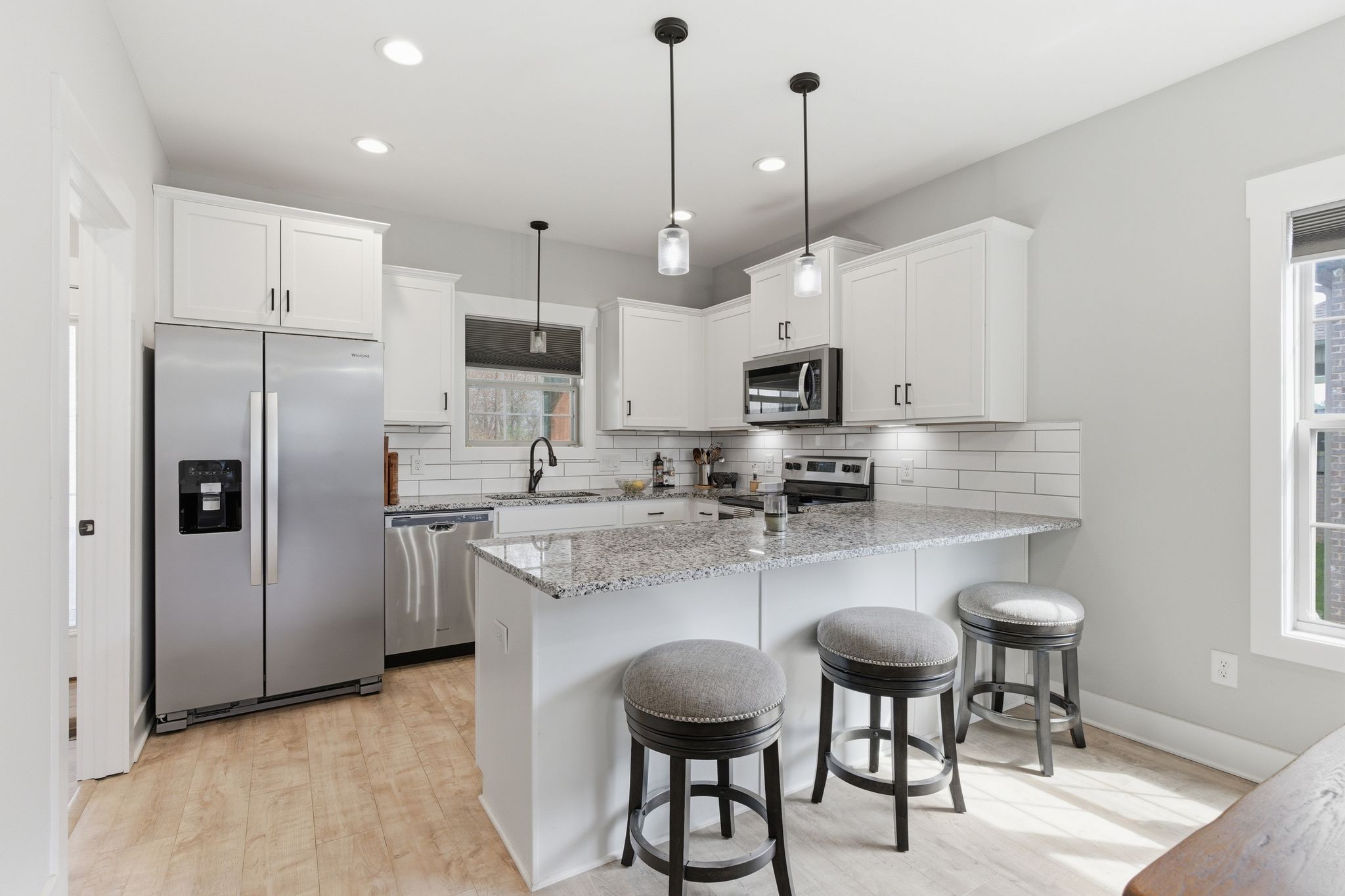 217 Julia Ann Court Springfield, TN 37172 - Photo 8 of 26 a kitchen with stainless steel appliances granite countertop a sink a stove a refrigerator and chairs