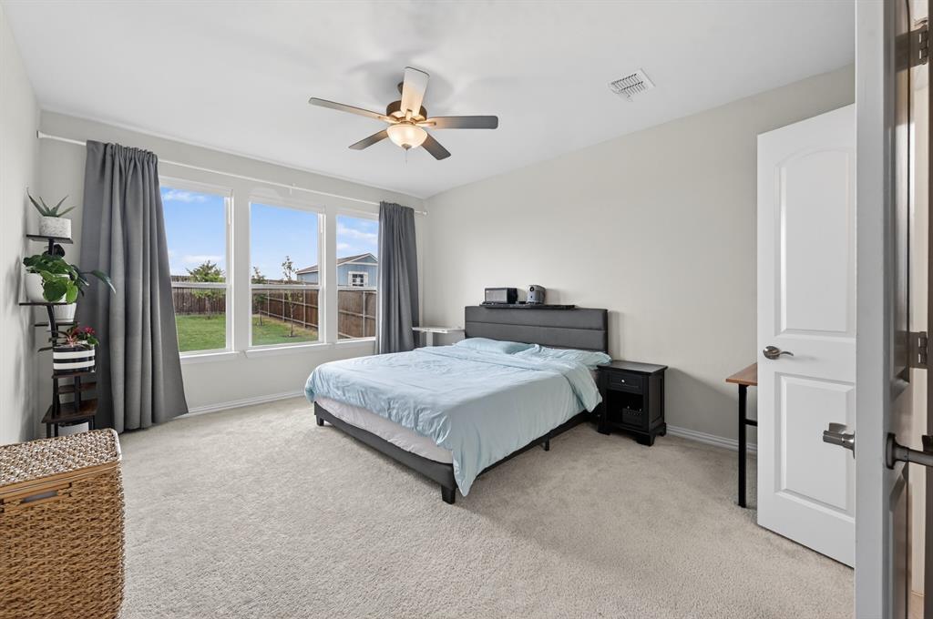 11320 Twisting Peak Road Fort Worth, TX 76052 - Photo 11 of 23 a spacious bedroom with a bed and a chandelier