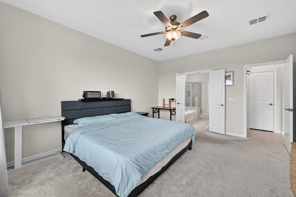 11320 Twisting Peak Road Fort Worth, TX 76052 - Photo 12 of 23 a bedroom with a bed and a ceiling fan