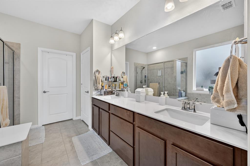 11320 Twisting Peak Road Fort Worth, TX 76052 - Photo 13 of 23 a bathroom with a double vanity sink a mirror and a