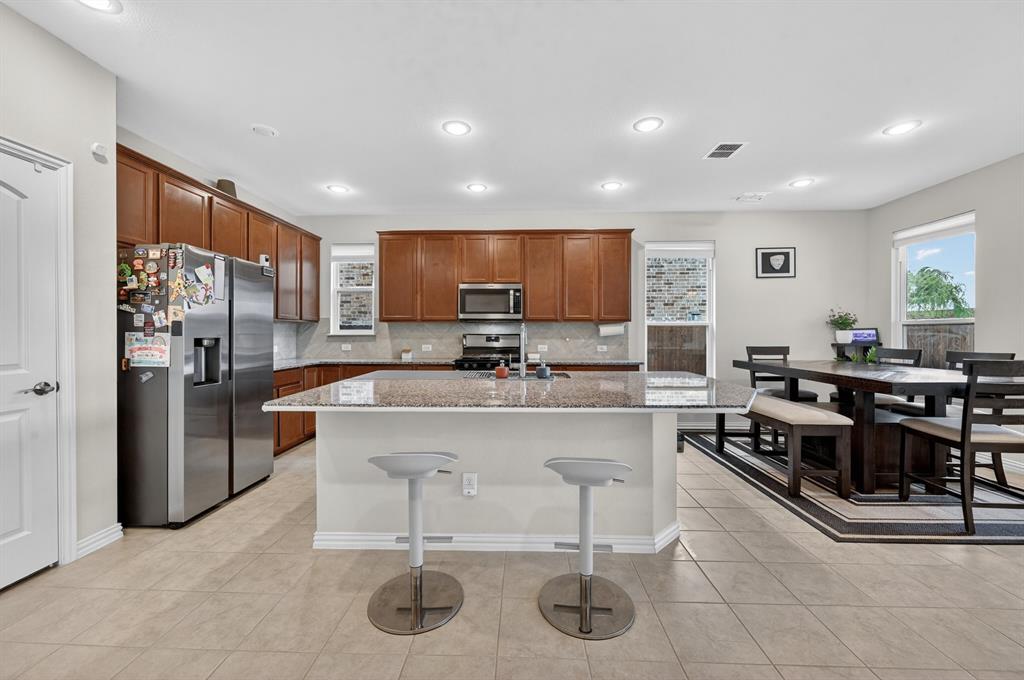 11320 Twisting Peak Road Fort Worth, TX 76052 - Photo 7 of 23 a living room with stainless steel appliances kitchen island granite countertop furniture and a refrigerator
