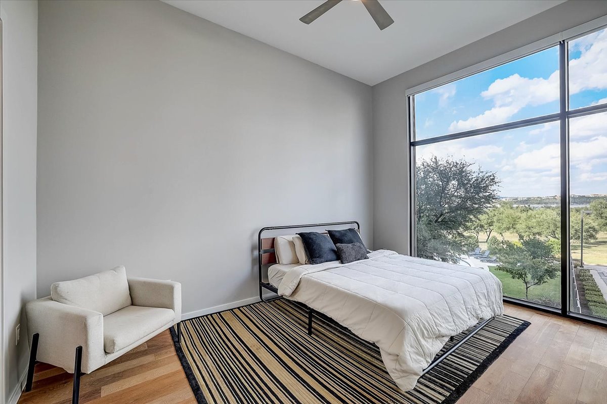 5921 Hiline Road, Unit 1204 Austin, TX 78734 - Photo 23 of 36 Bedroom featuring light wood finished floors and a ceiling fan