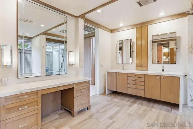 a room with two mirror and a sink