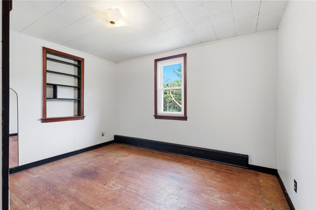 1033 Walt Road Pennsburg, PA 18073 - Photo 27 of 40 Original hardwood floors and built-in shelving define this classic bedroom space.