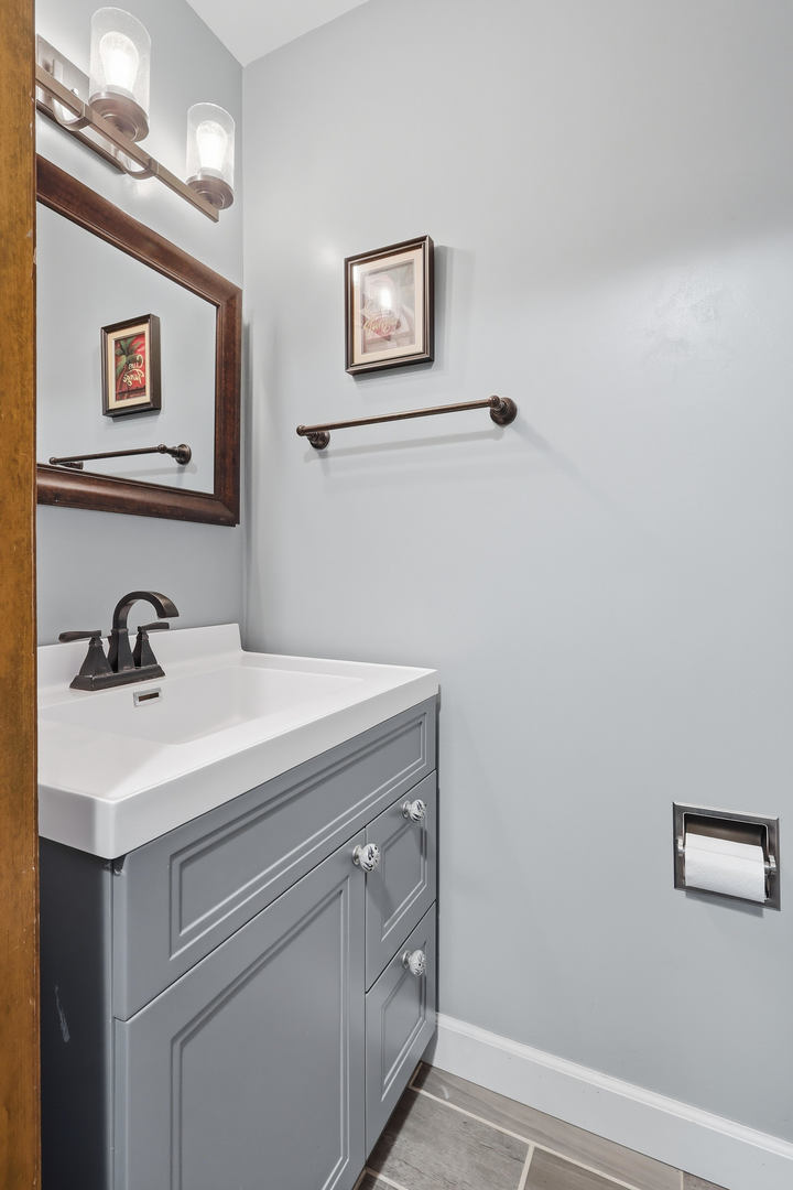 4314 Spring Street Davenport, IA 52807 - Photo 40 of 51 a bathroom with a sink and a mirror