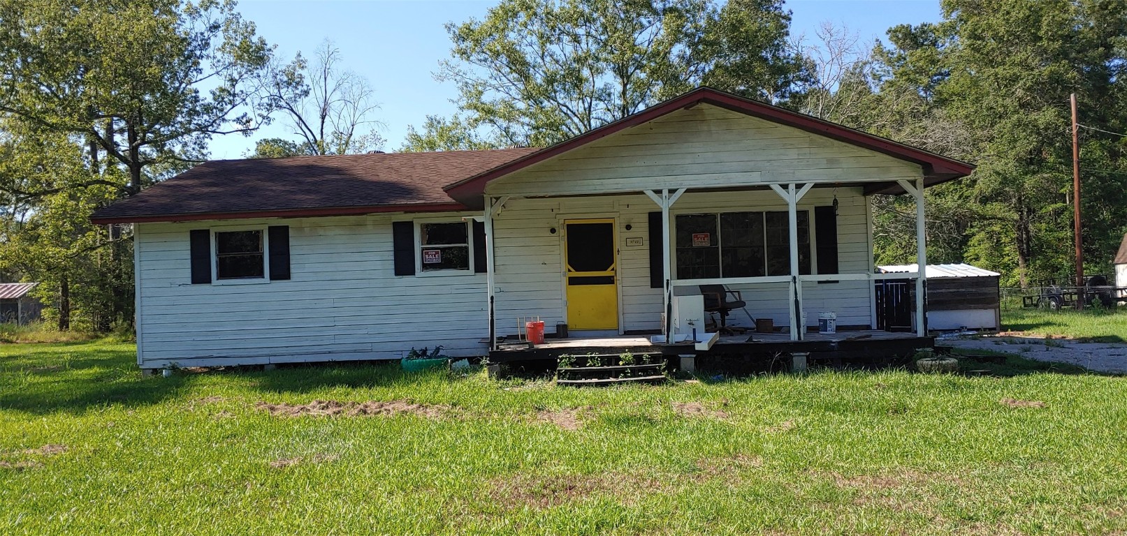 9743 Westbend Road Orange, TX 77632 - Photo 1 of 24 a front view of a house with a garden and deck