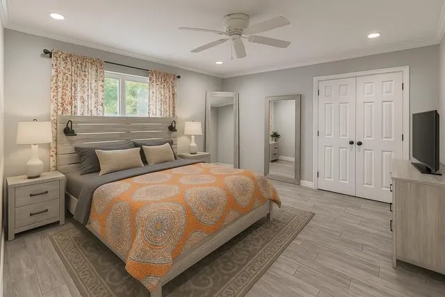 a spacious bedroom with a bed and a flat screen tv