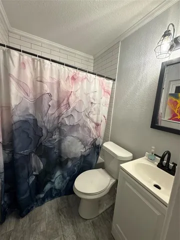 a white toilet sitting next to a bathroom sink