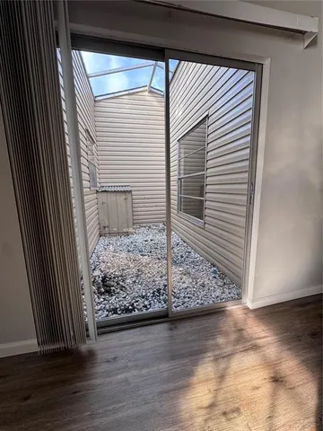 a view of a livingroom with wooden floor and chair