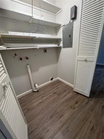 a view of an empty room with wooden floor