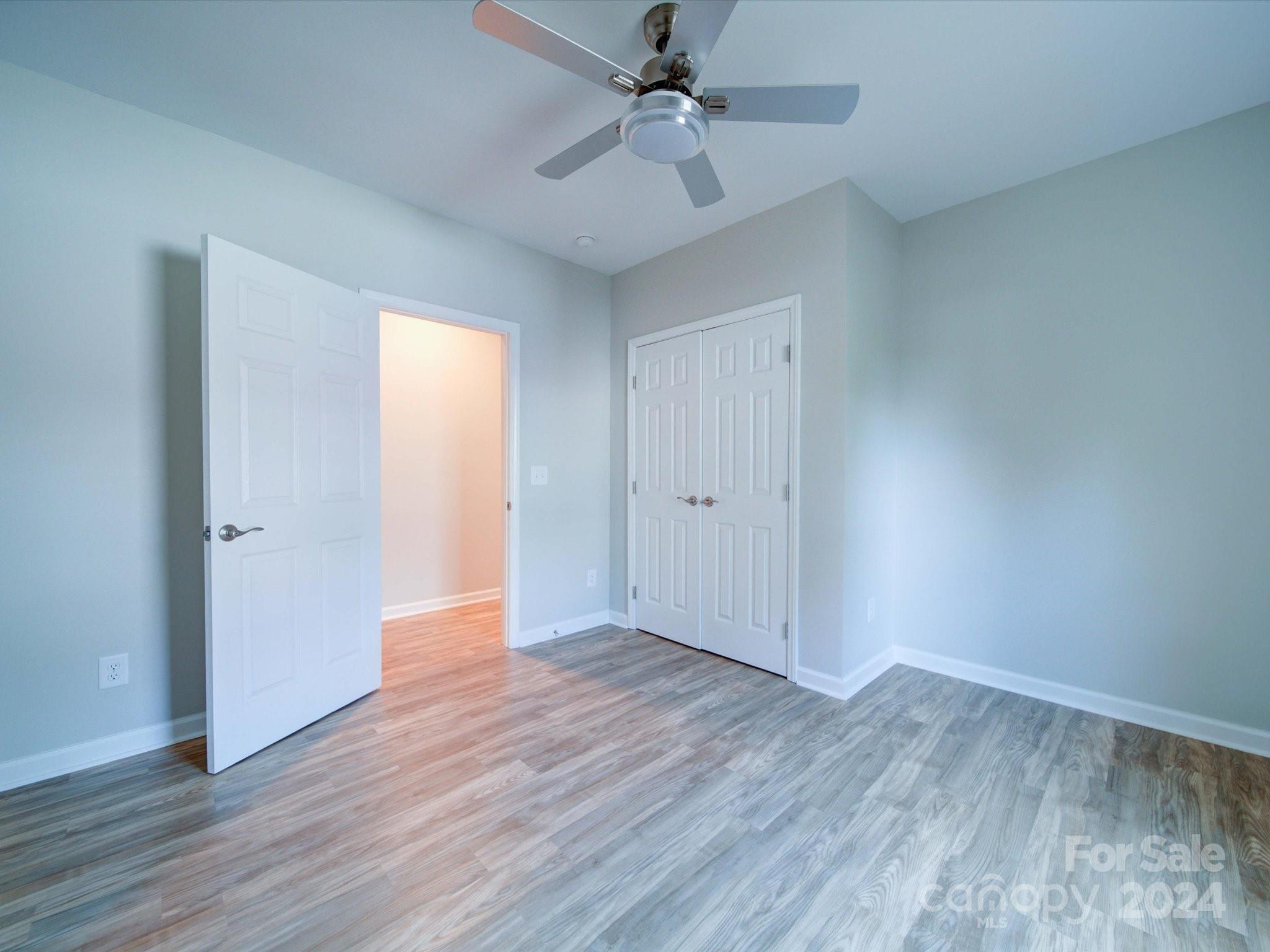 113 Graham Street Chester, SC 29706 - Photo 17 of 22 an empty room with wooden floor ceiling fan and windows