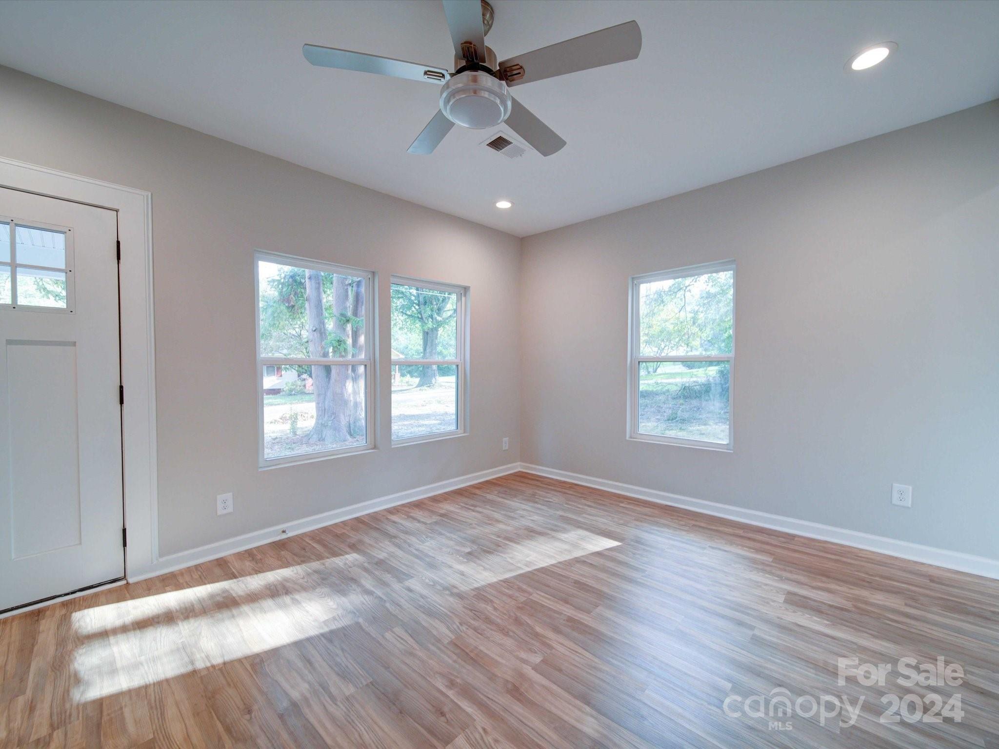 113 Graham Street Chester, SC 29706 - Photo 5 of 22 a view of an empty room with a window and wooden floor
