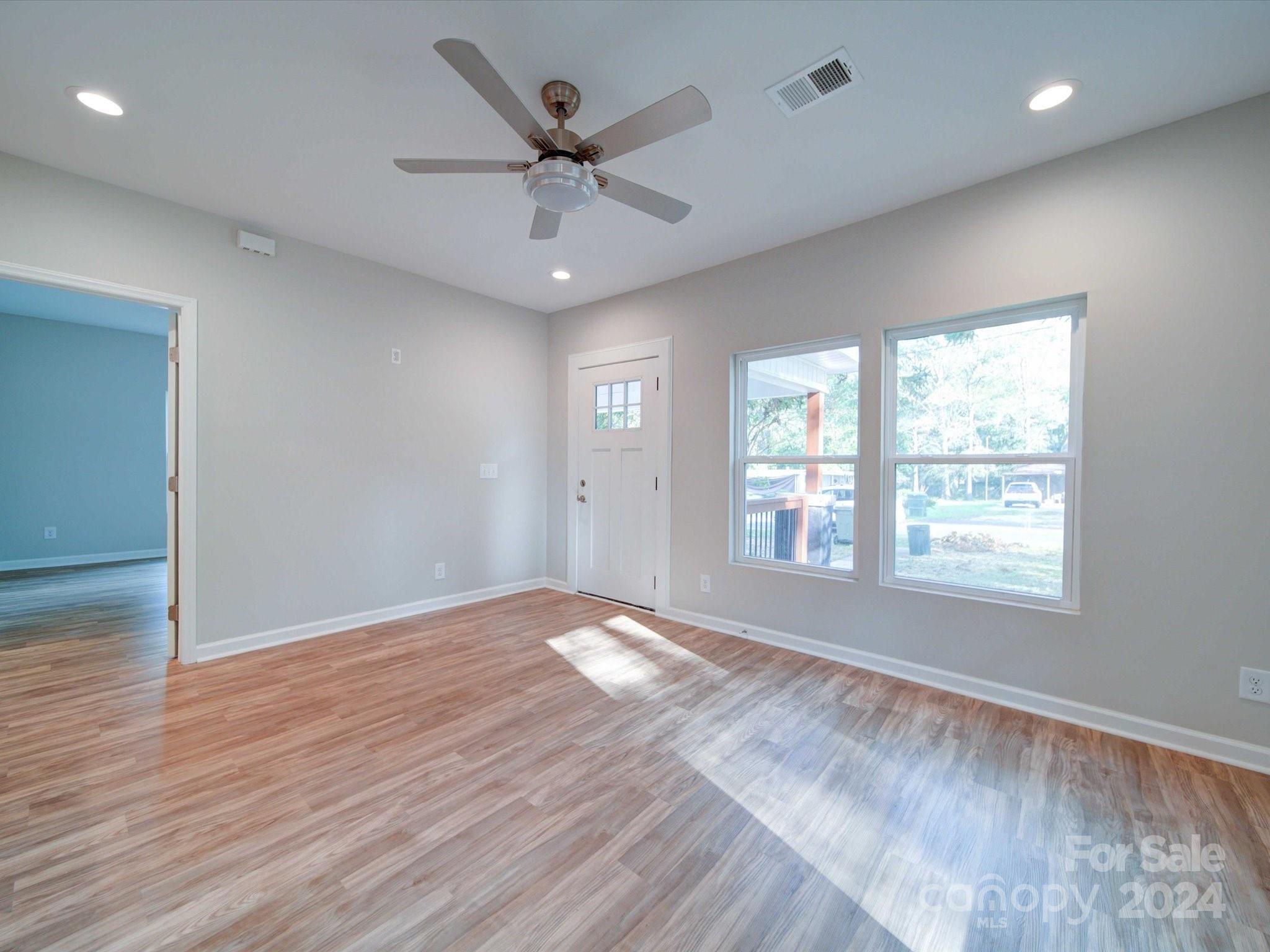 113 Graham Street Chester, SC 29706 - Photo 6 of 22 a view of an empty room with a window and wooden floor