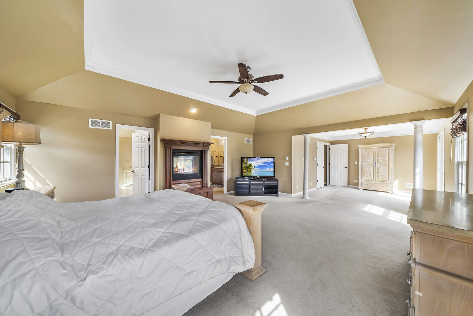 40W885 Campton Trail Road St. Charles, IL 60175 - Photo 15 of 29 a large bed sitting in a spacious bedroom next to a window and a chandelier