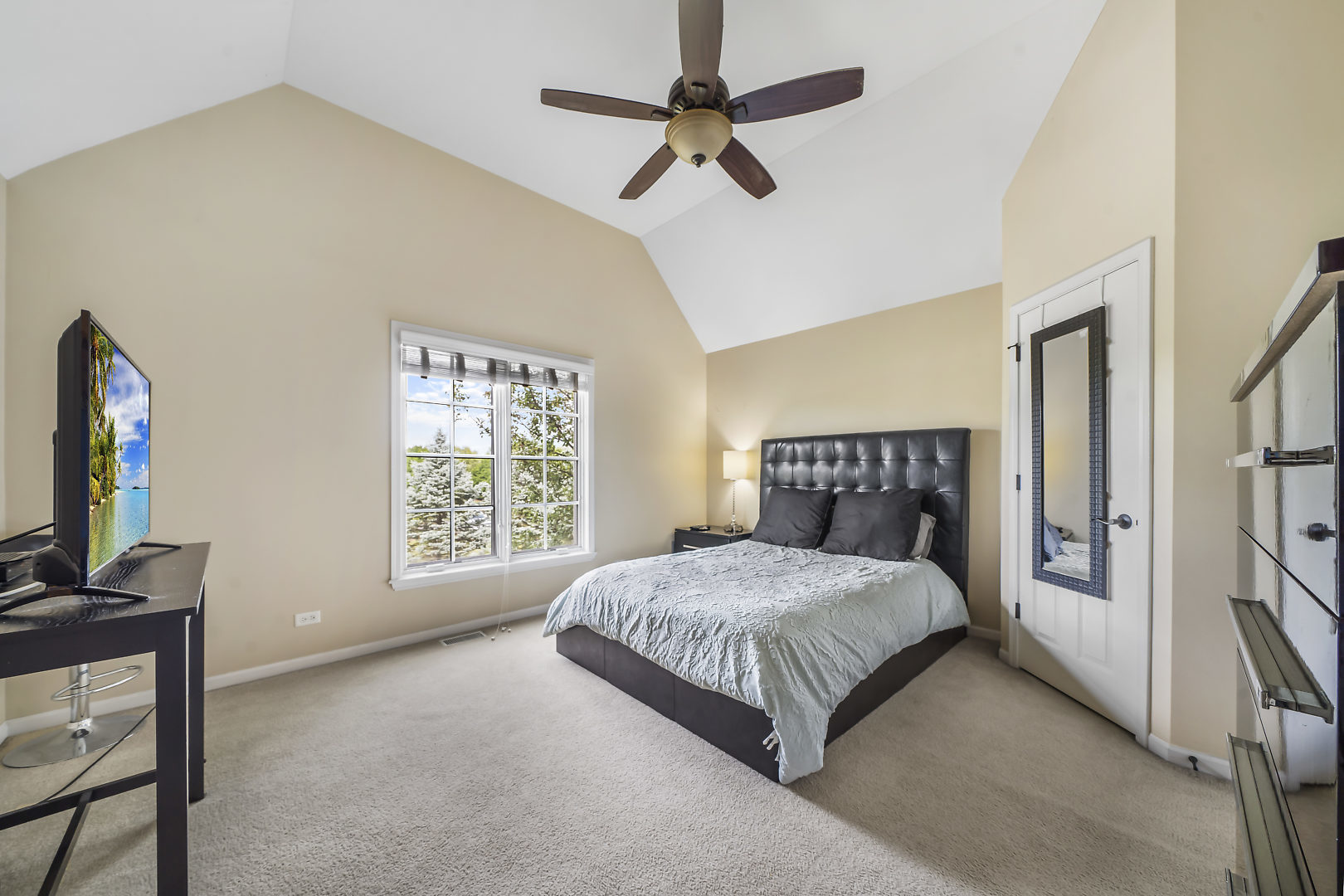 40W885 Campton Trail Road St. Charles, IL 60175 - Photo 20 of 29 a bedroom with a bed a flat screen tv and a window