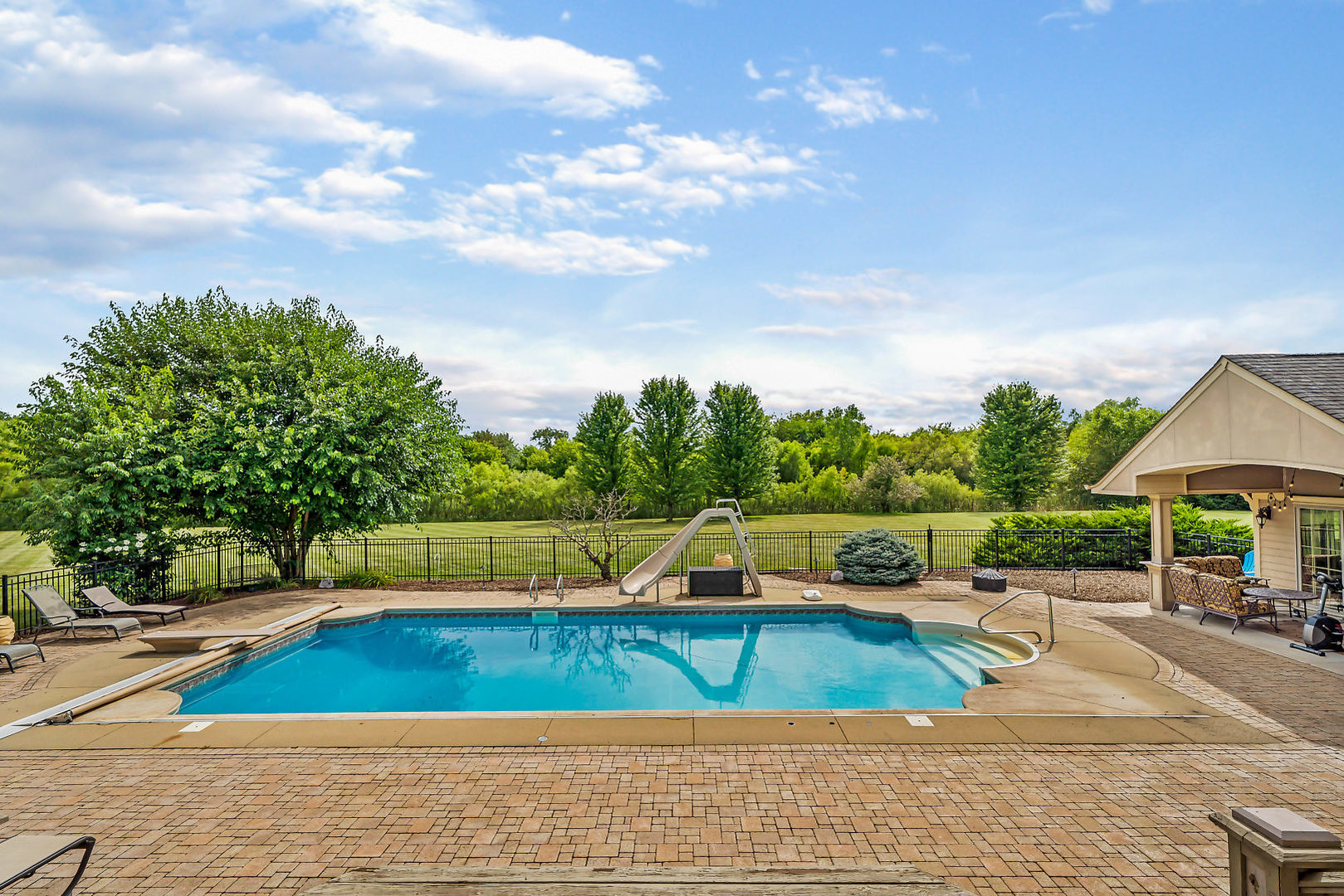 40W885 Campton Trail Road St. Charles, IL 60175 - Photo 24 of 29 a view of a swimming pool with a lounge chair