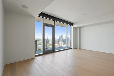 wooden floor in an empty room with a window
