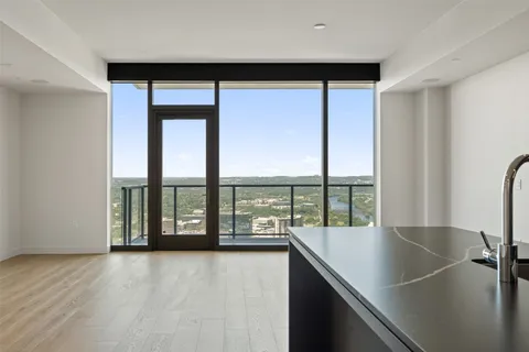 a large kitchen with granite countertop a sink and a stove top oven