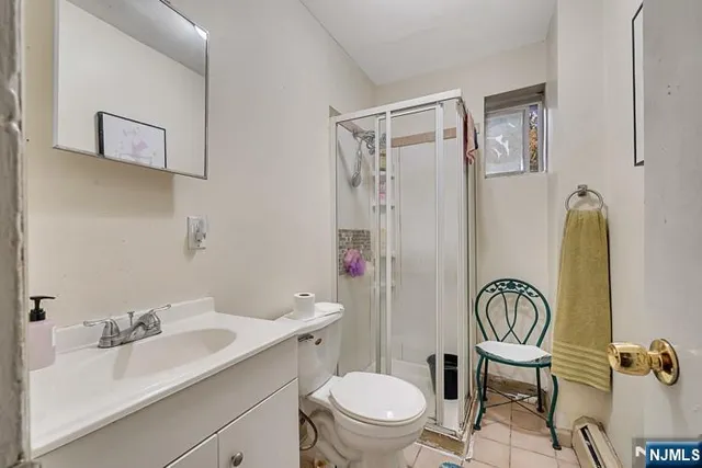 a bathroom with a sink toilet a mirror and shower