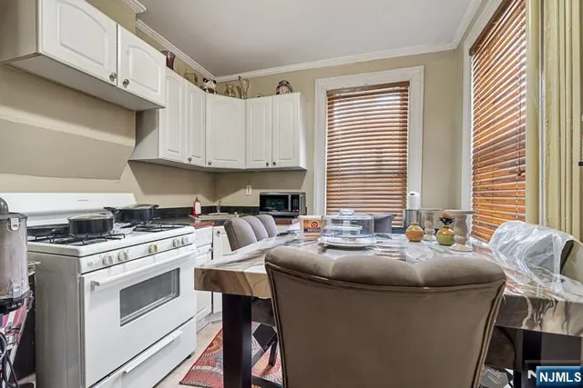 a kitchen with appliances a sink and cabinets