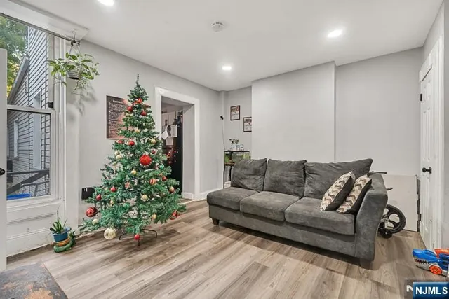 a living room with furniture and flowers