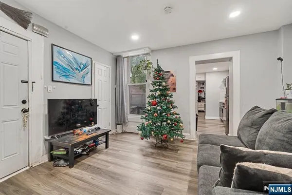 a living room with furniture a flat screen tv and a fireplace