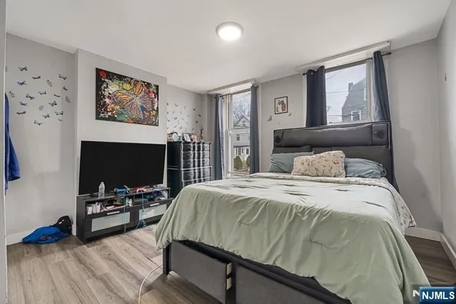 a bedroom with a bed and a flat screen tv