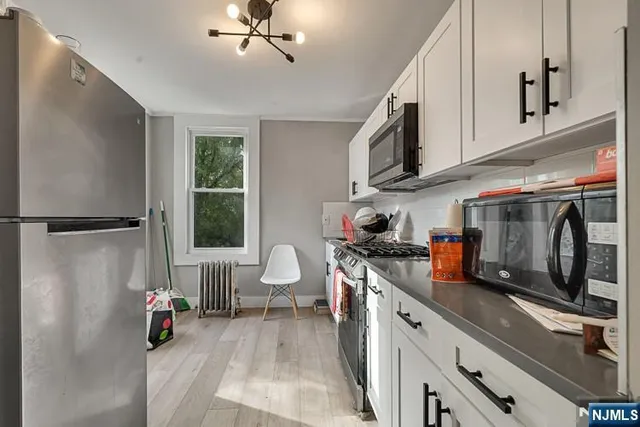 a kitchen with stainless steel appliances a sink stove and cabinets