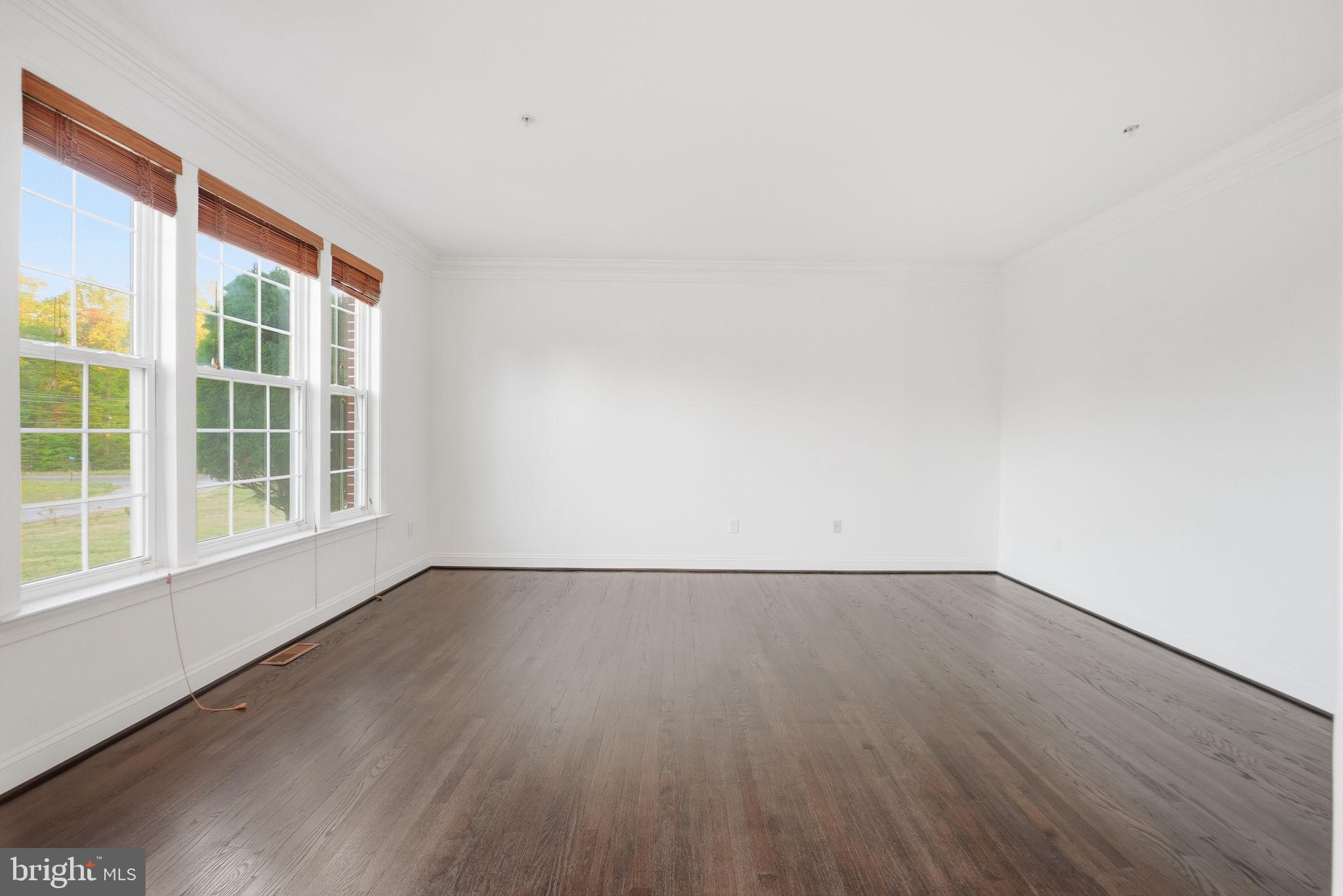 19081 Poplar Ridge Road Brandywine, MD 20613 - Photo 21 of 64 an empty room with wooden floor and windows