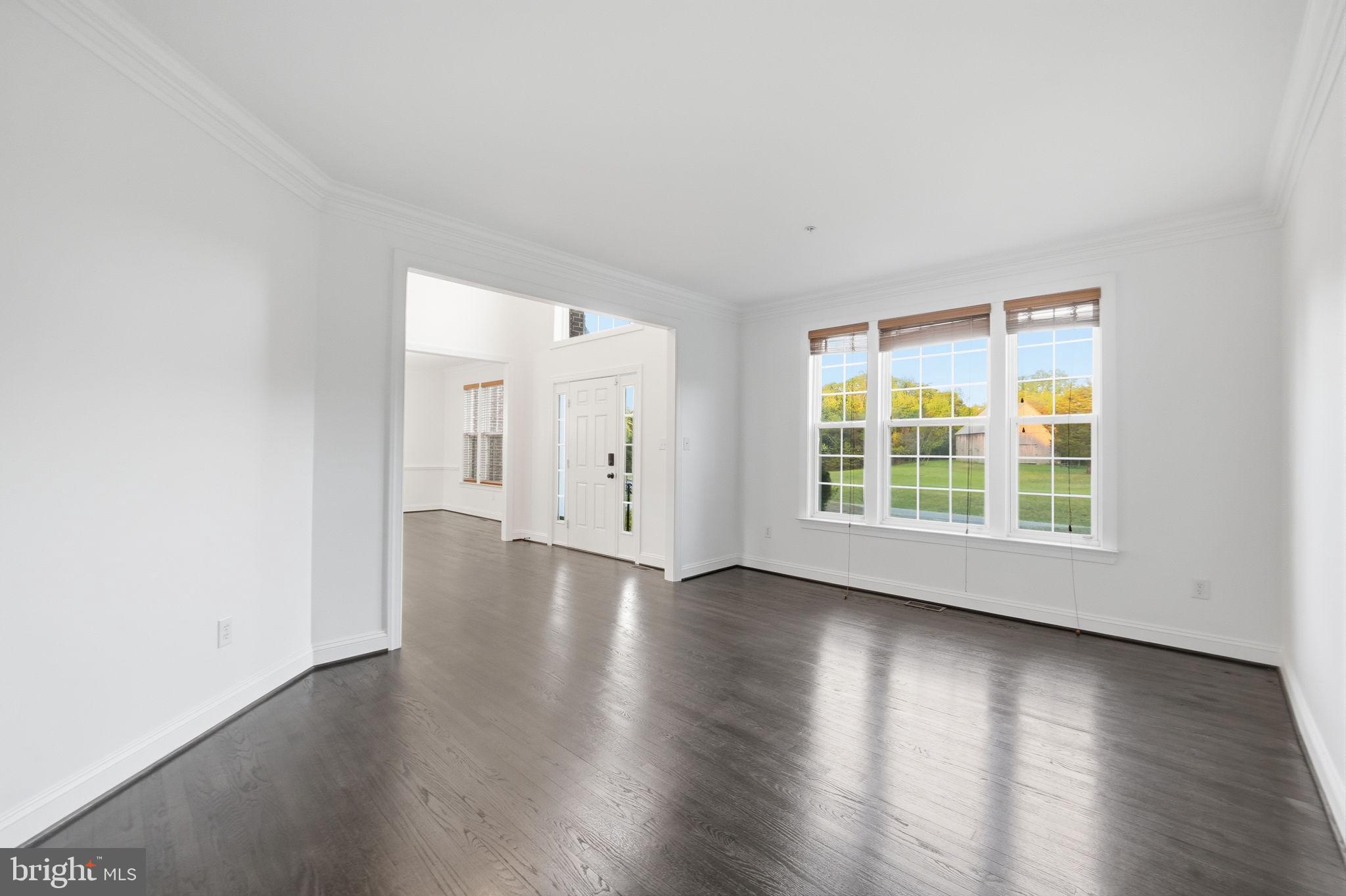 19081 Poplar Ridge Road Brandywine, MD 20613 - Photo 22 of 64 an empty room with wooden floor and windows