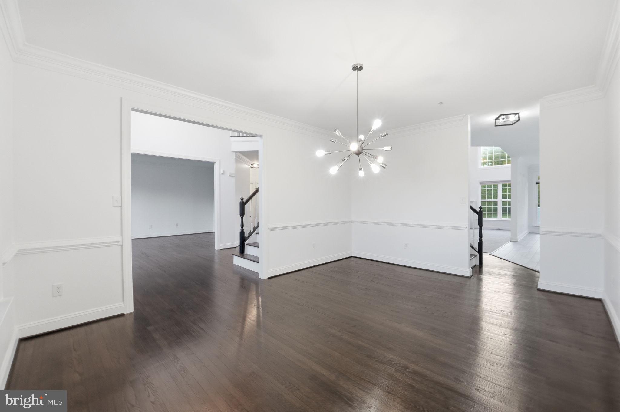 19081 Poplar Ridge Road Brandywine, MD 20613 - Photo 25 of 64 a view of an empty room with wooden floor and a chandelier