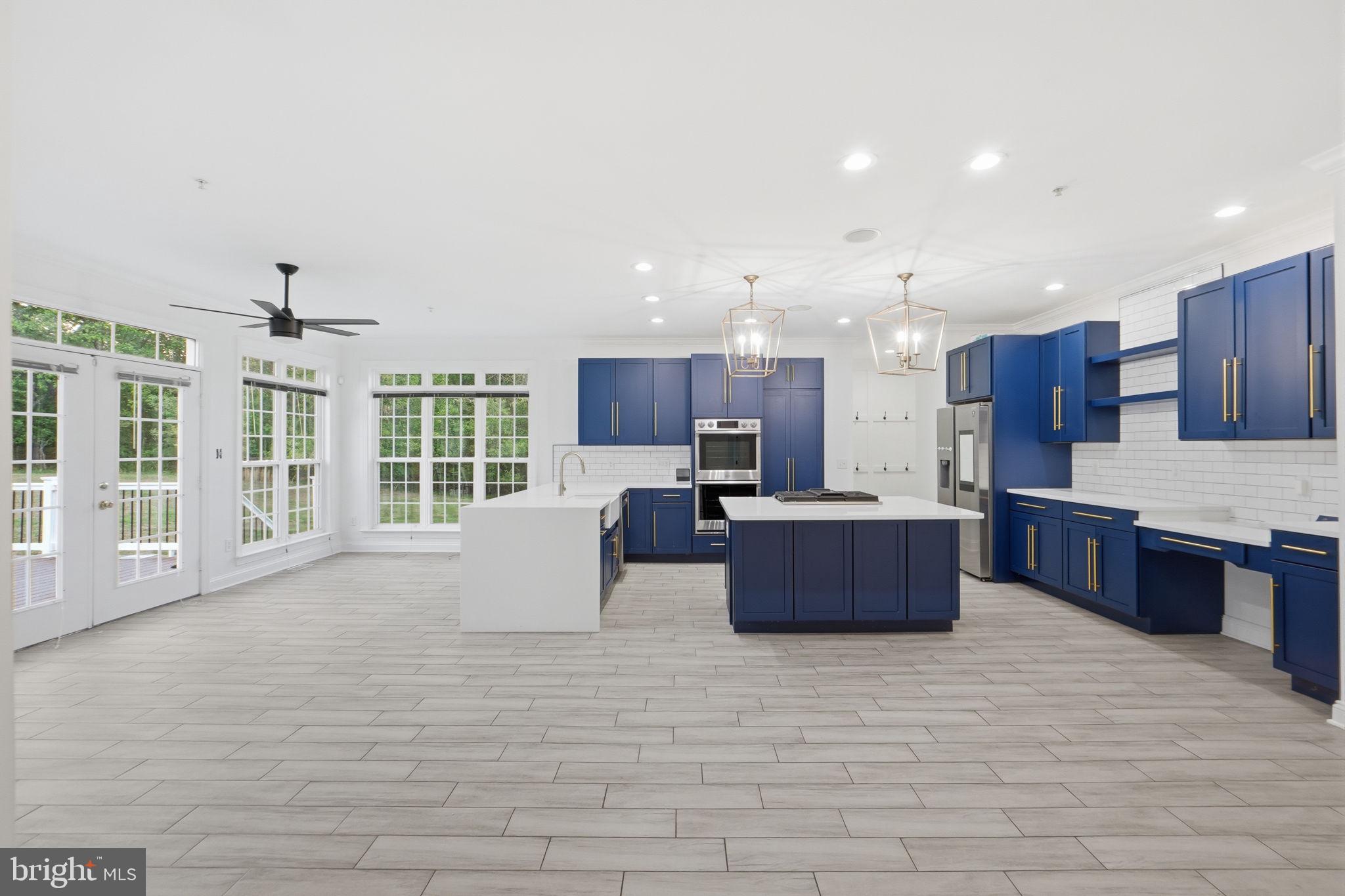 19081 Poplar Ridge Road Brandywine, MD 20613 - Photo 32 of 64 a large kitchen with kitchen island a large counter space and stainless steel appliances