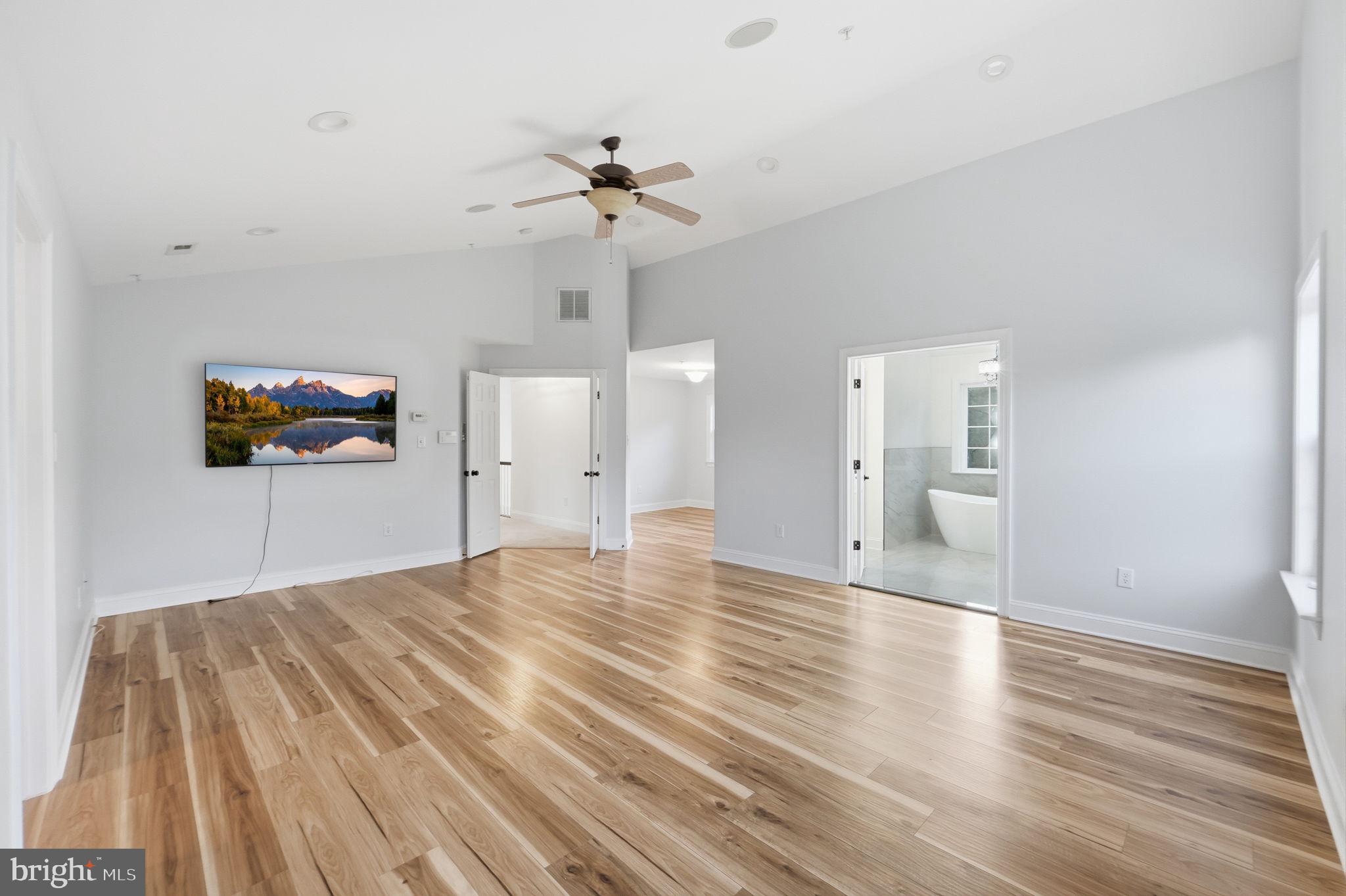 19081 Poplar Ridge Road Brandywine, MD 20613 - Photo 44 of 64 a view of a room with wooden floor and a ceiling fan