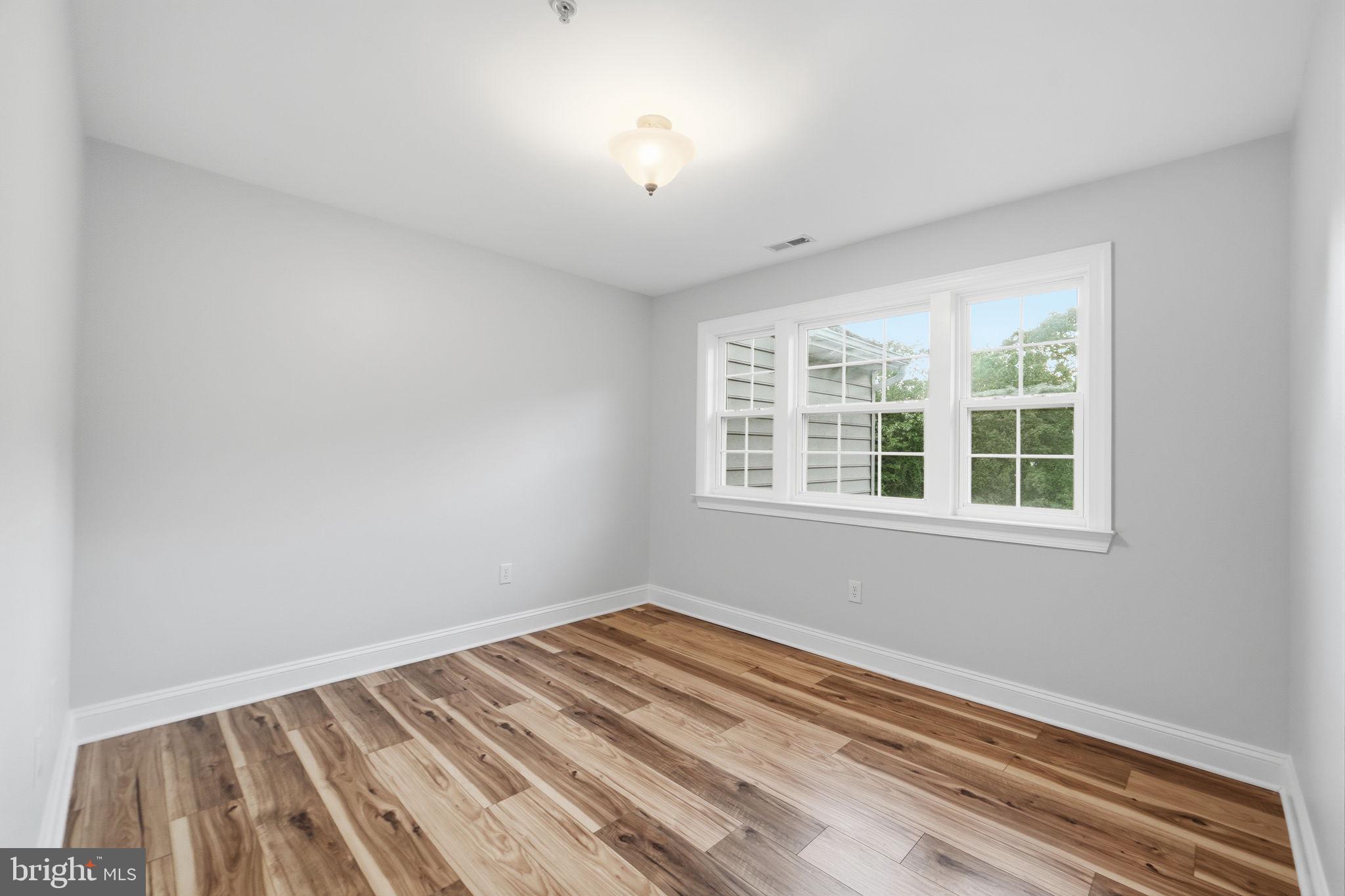 19081 Poplar Ridge Road Brandywine, MD 20613 - Photo 45 of 64 a view of a room with wooden floor and windows