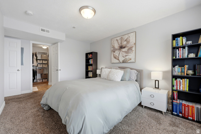116 East Resaca Drive, Unit F6 Sandy, UT 84070 - Photo 19 of 32 Carpeted room featuring a built-in closet with double white panel doors and an interior lighting fixture