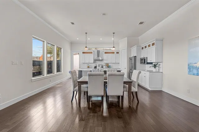 a dining room with kitchen island a table and chairs