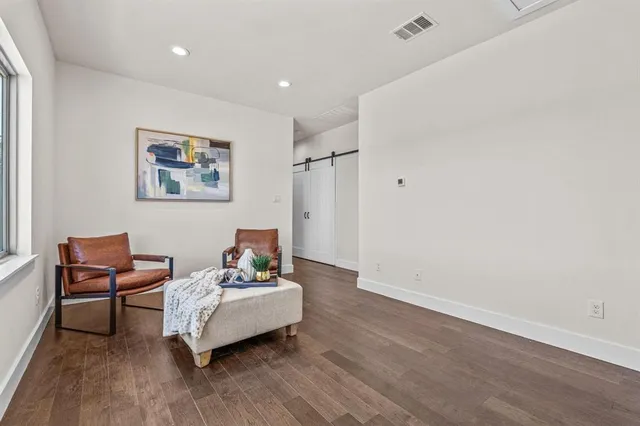 a view of a livingroom with furniture and wooden floor