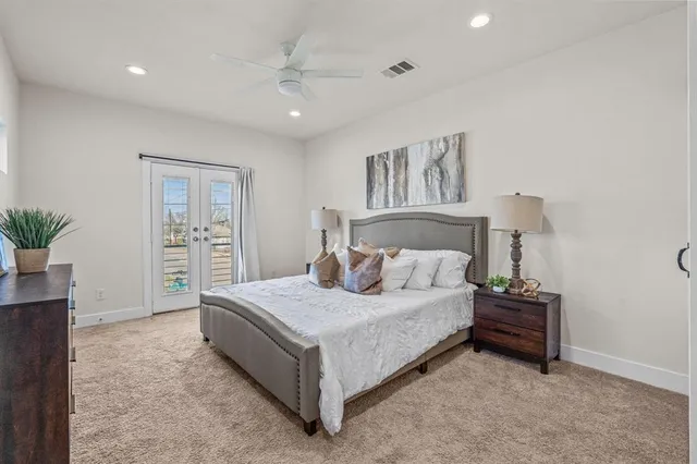 a bedroom with a bed and a potted plant